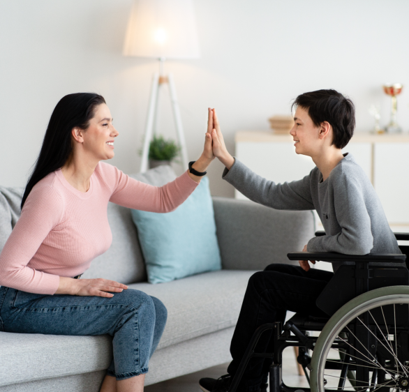 a child on a wheelchair with a caregiver