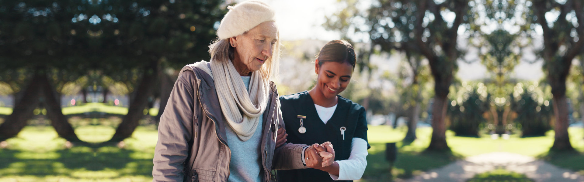 caregiver and walking with senior woman